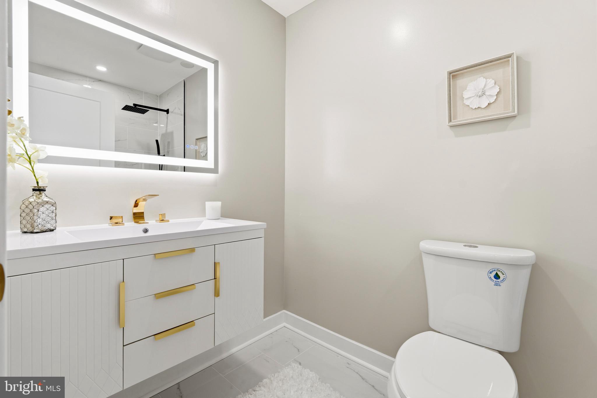 1840 Post Oak Trail Reston, VA 20191 - Photo 33 of 46 a bathroom with a toilet sink vanity and mirror