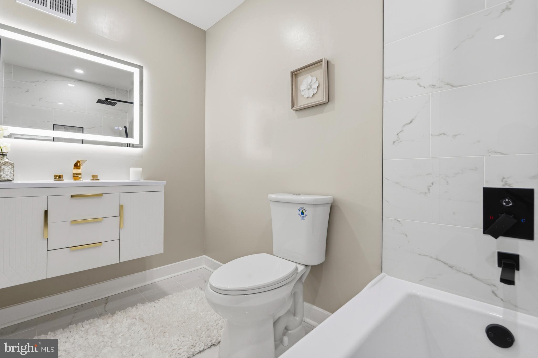 1840 Post Oak Trail Reston, VA 20191 - Photo 34 of 46 a bathroom with a sink toilet and vanity