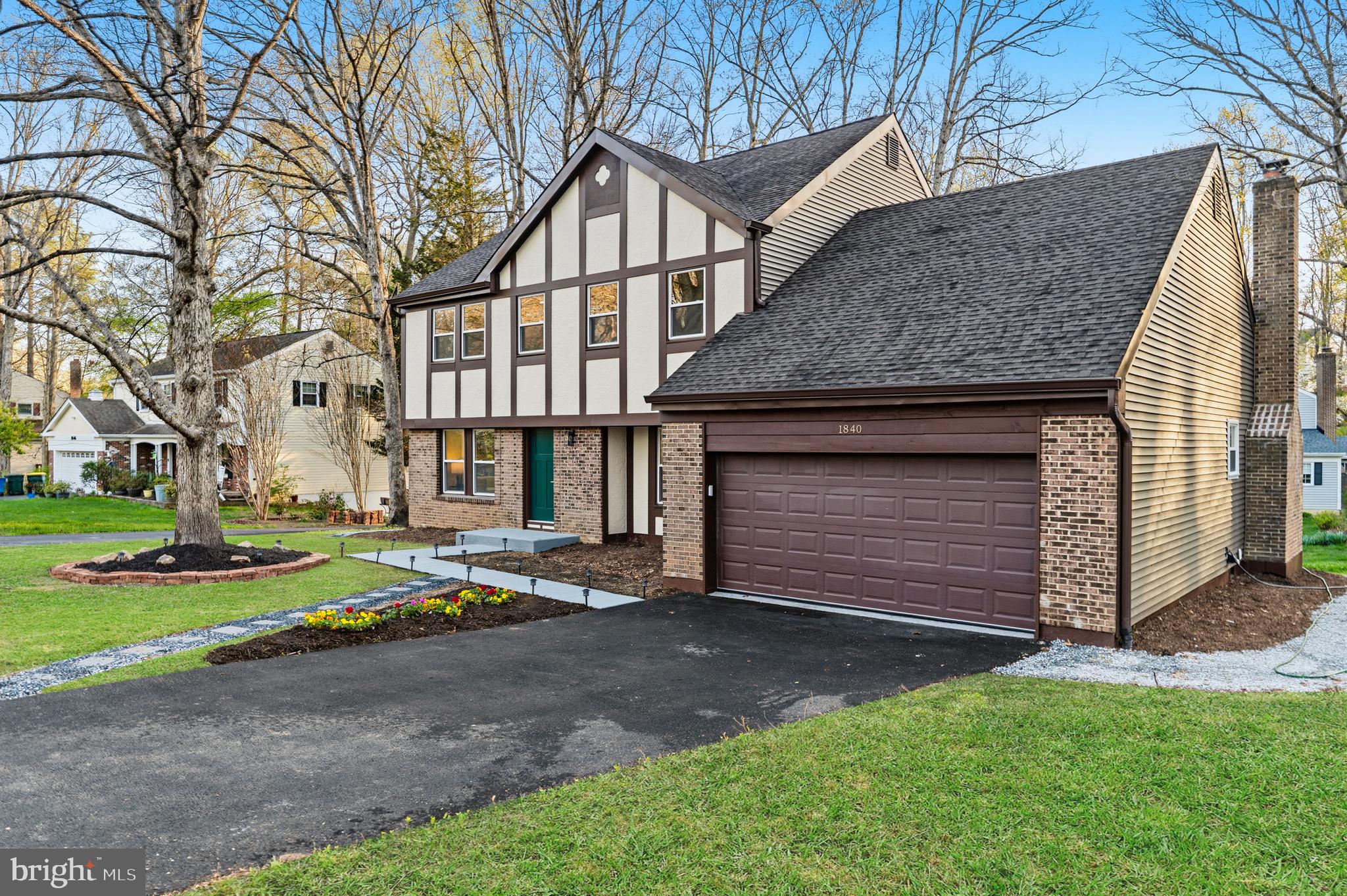 1840 Post Oak Trail Reston, VA 20191 - Photo 4 of 47 a front view of a house with a yard and garage