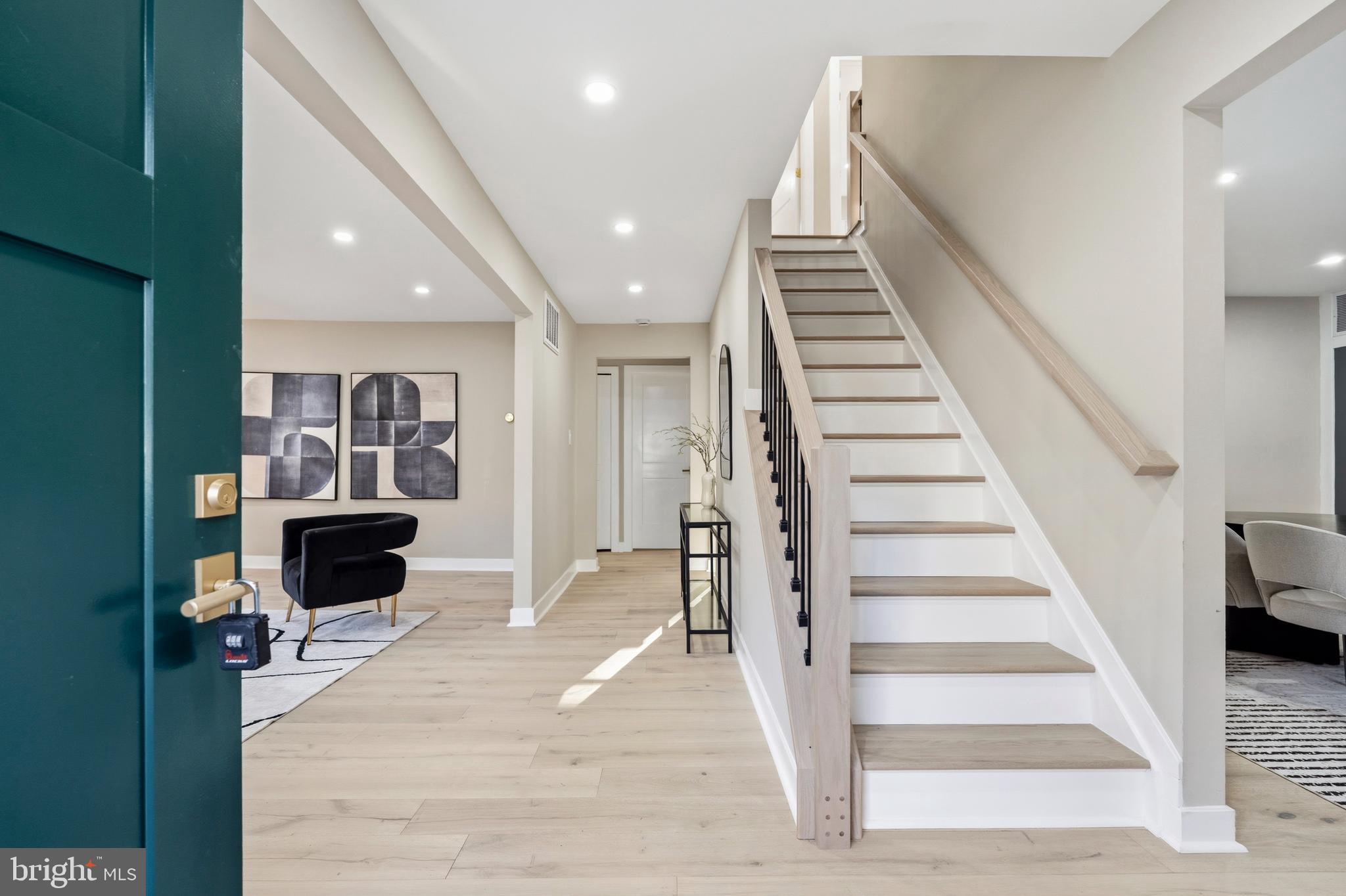 1840 Post Oak Trail Reston, VA 20191 - Photo 5 of 47 a view of a living room with wooden floor and stairs
