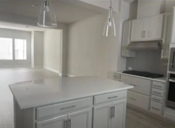 a kitchen with stainless steel appliances a stove sink and cabinets