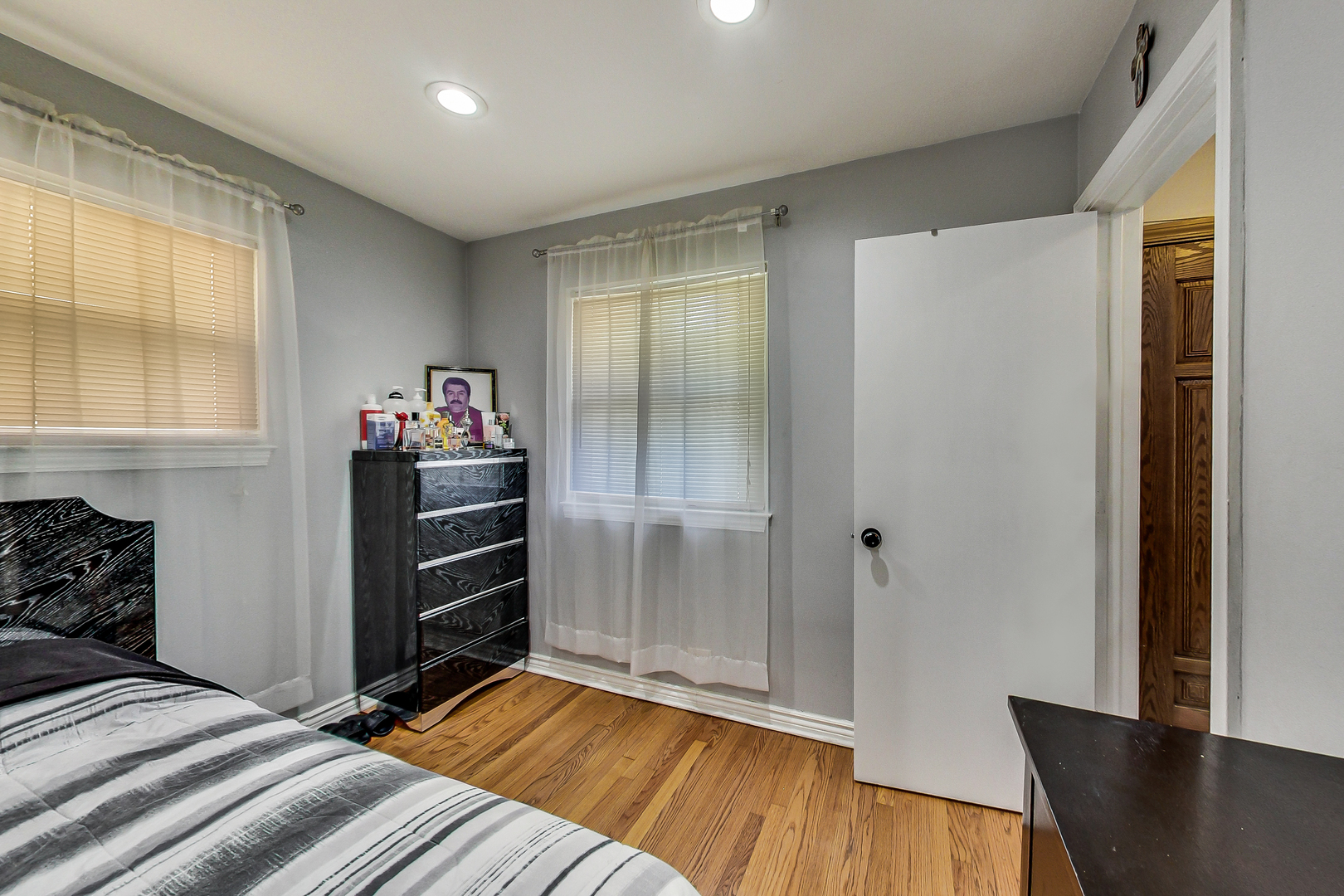 Undisclosed Address Chicago, IL 60625 - Photo 19 of 30 a bedroom with a bed and wooden floor