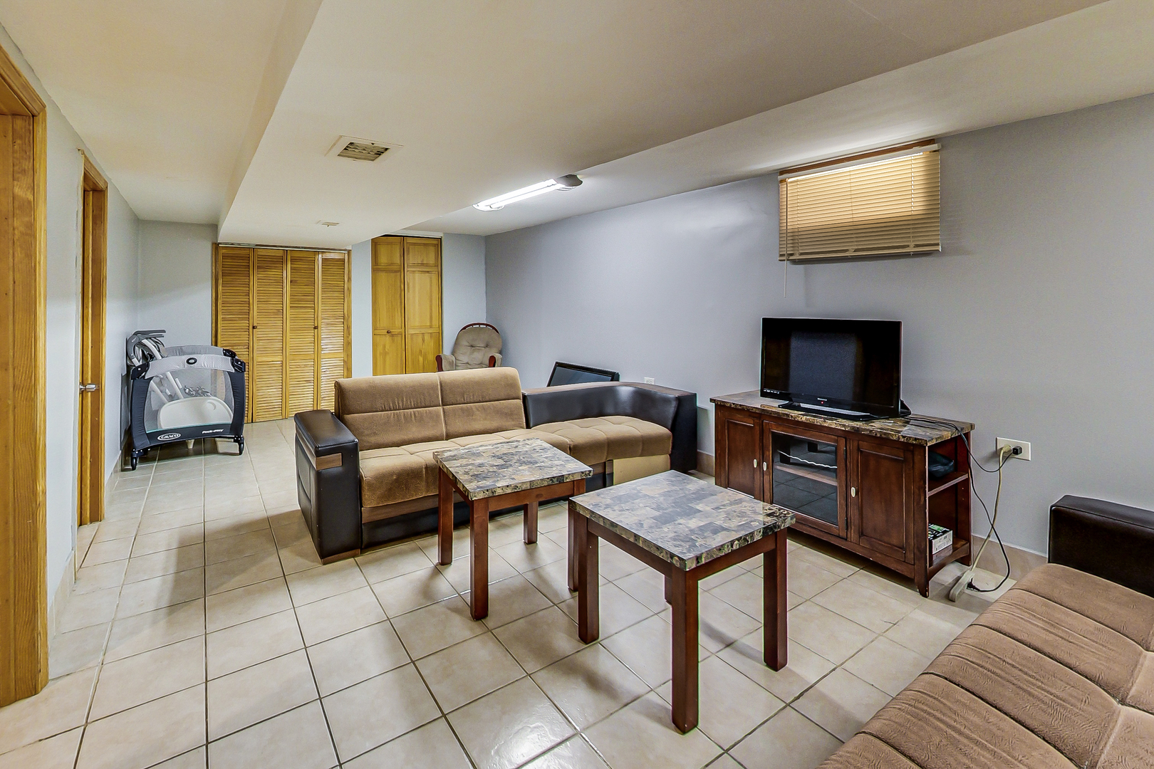 Undisclosed Address Chicago, IL 60625 - Photo 21 of 30 a living room with furniture and a flat screen tv