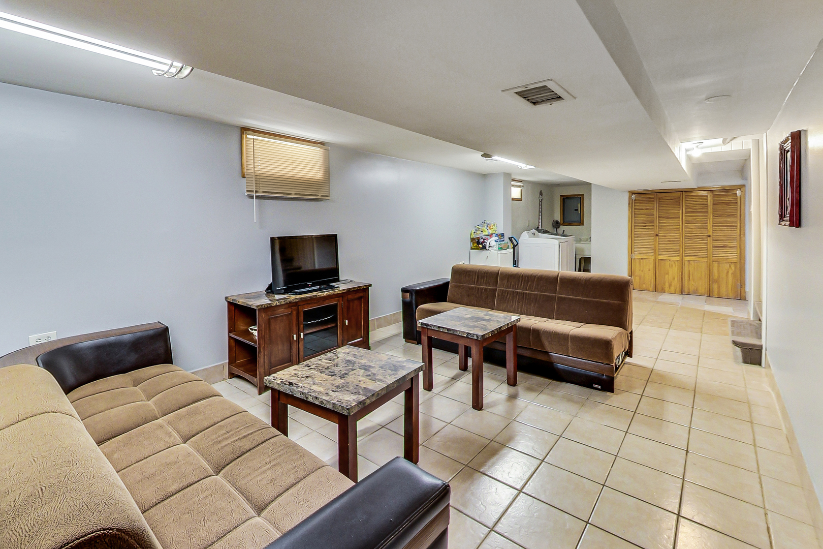 Undisclosed Address Chicago, IL 60625 - Photo 23 of 30 a living room with furniture and a flat screen tv