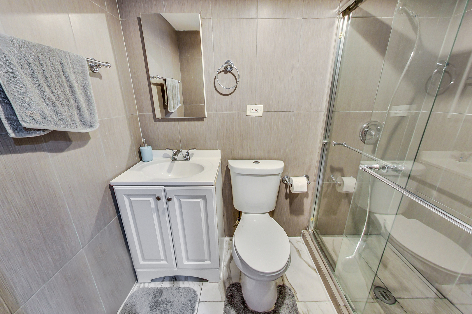 Undisclosed Address Chicago, IL 60625 - Photo 28 of 30 a white toilet sitting next to a bathroom sink