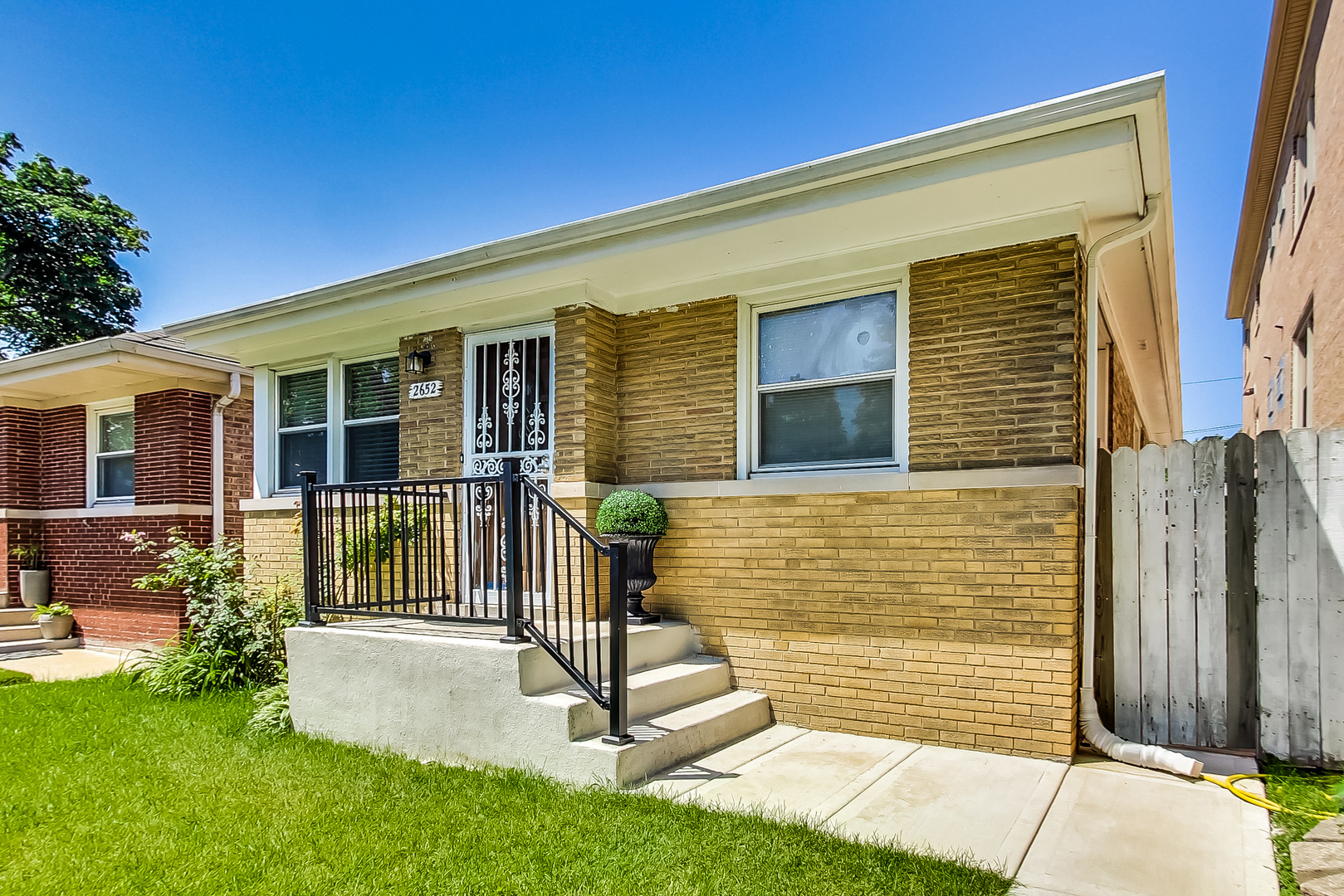 Undisclosed Address Chicago, IL 60625 - Photo 3 of 30 a front view of a house with a garden