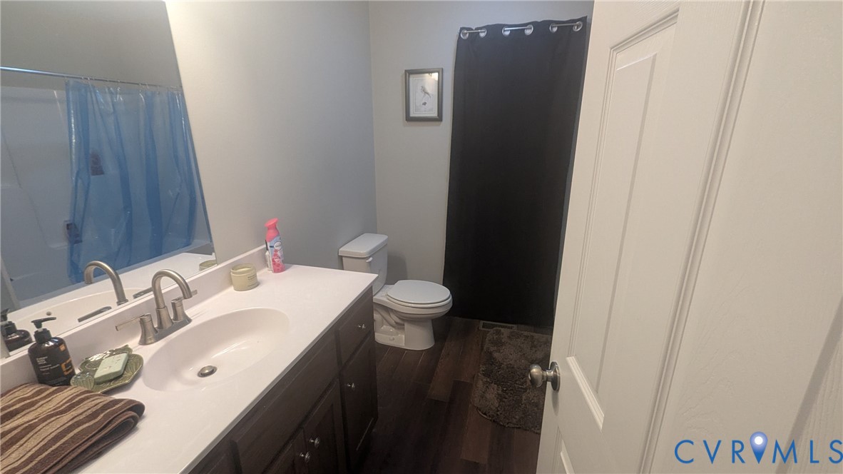 24580 St James Road Jetersville, VA 23083 - Photo 29 of 48 Bathroom featuring wood-finish flooring, a dark wo