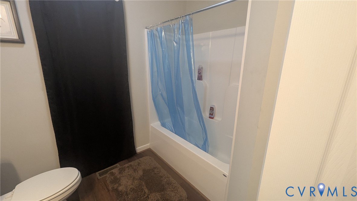 24580 St James Road Jetersville, VA 23083 - Photo 31 of 48 White bathtub and shower combination unit with woo