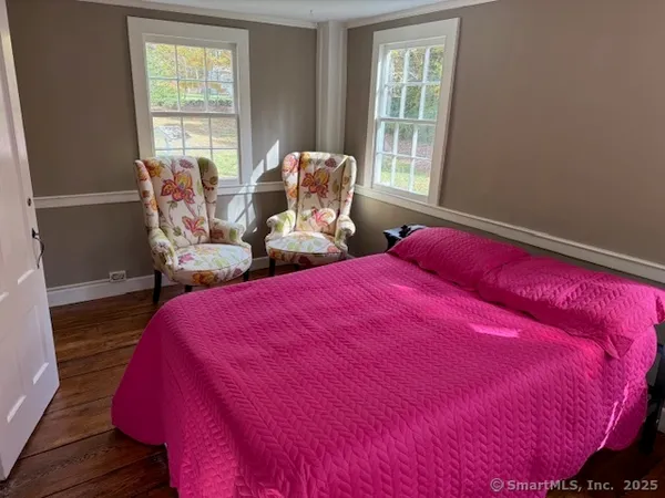 a bed sitting in a bedroom next to a window