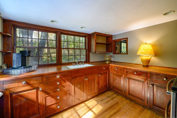 a spacious bathroom with a granite countertop sink and a large mirror