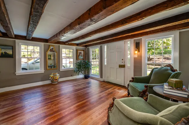 a view of an livingroom with furniture and windows