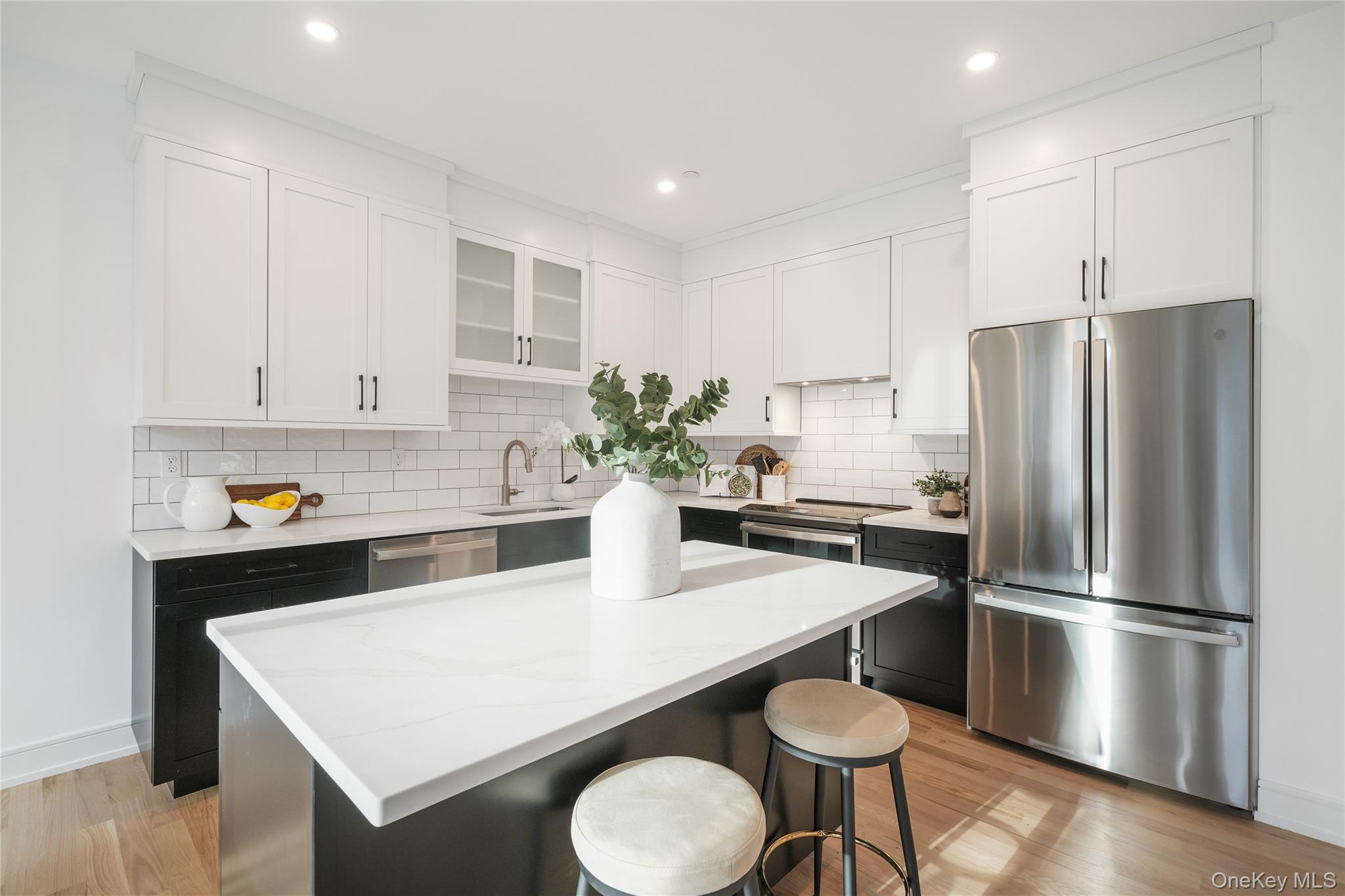2040 Crompond Road, Unit 22 Yorktown Heights, NY 10598 - Photo 5 of 19 Kitchen featuring stainless steel appliances, a kitchen breakfast bar, white cabinets, and a kitchen island