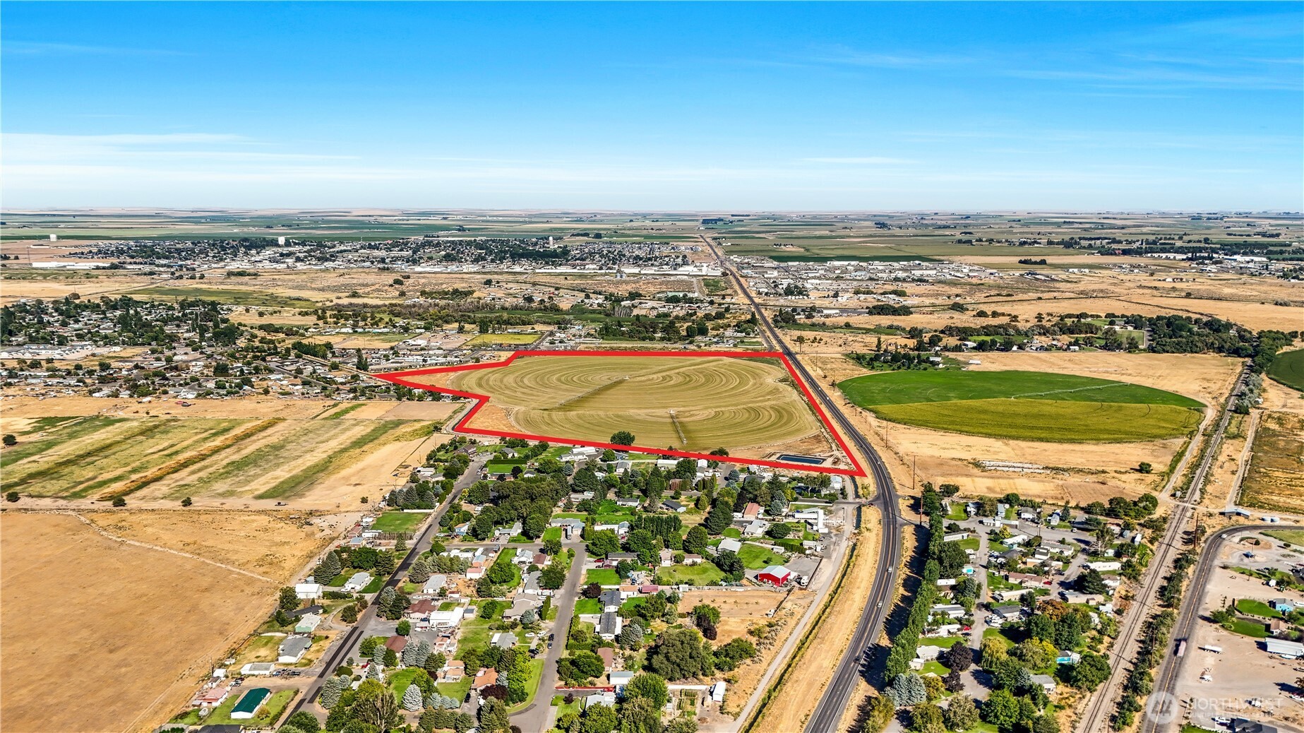 -na South Taylor Road Othello, WA 99344 - Photo 3 of 8 an aerial view of a swimming pool with a city view