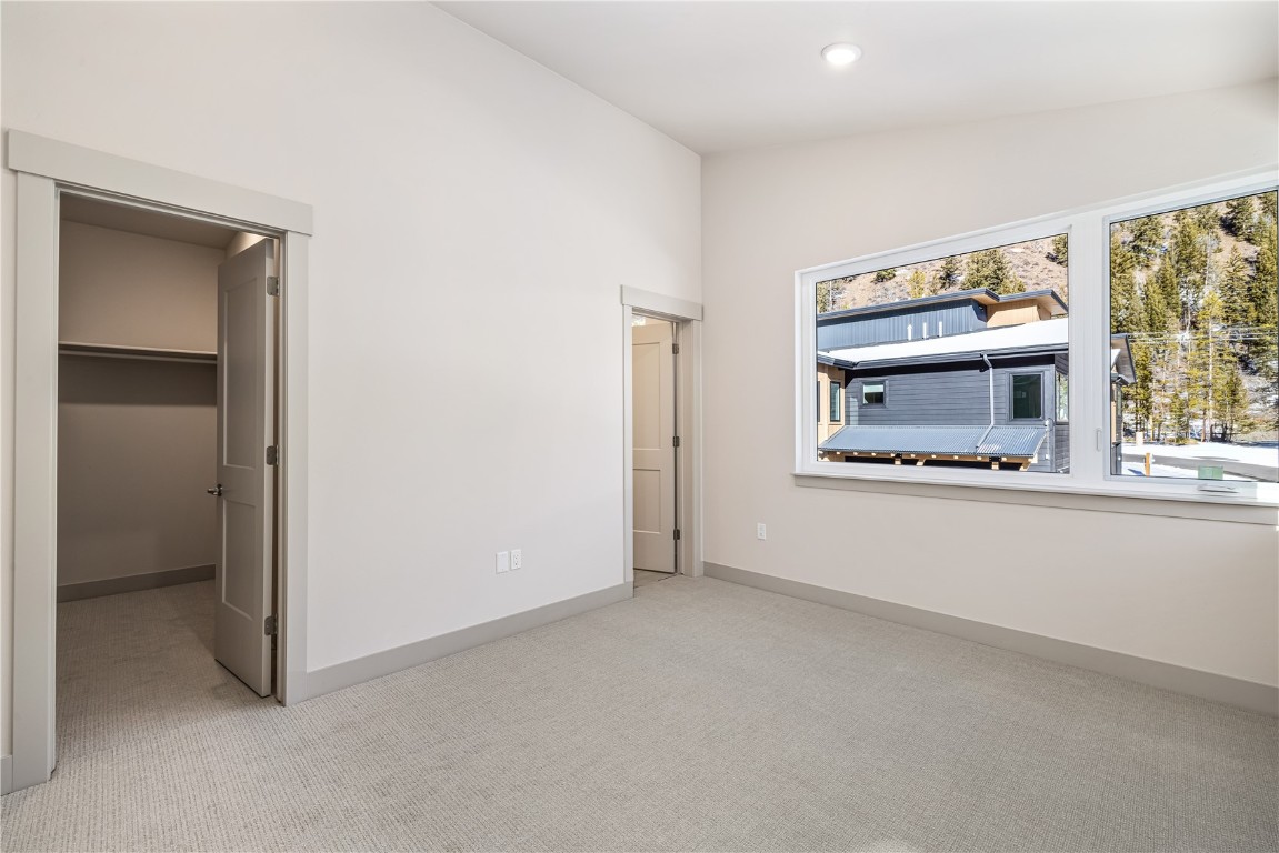 628 Montezuma Road, Unit D1 Keystone, CO 80435 - Photo 13 of 31 an empty room with windows and fireplace