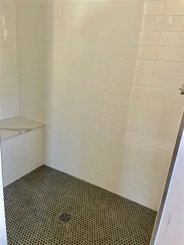 a bathroom with a bathtub and shower