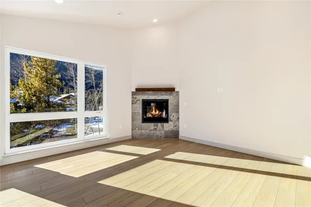 a view of an empty room with a window and fire pit