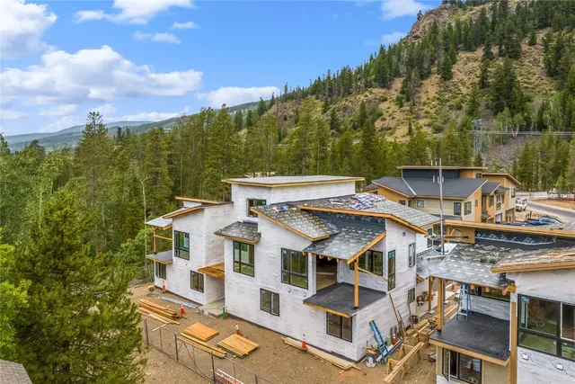 an aerial view of residential houses with outdoor space