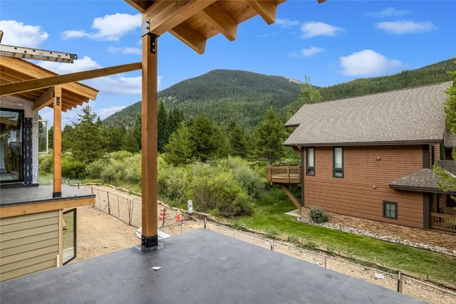 a view of a patio with a table and chairs under an umbrella