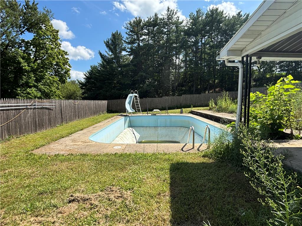 231 Laurel Road Lehighton, PA 18235 - Photo 31 of 36 Mature trees line the fenced backyard surrounding an in-ground pool.