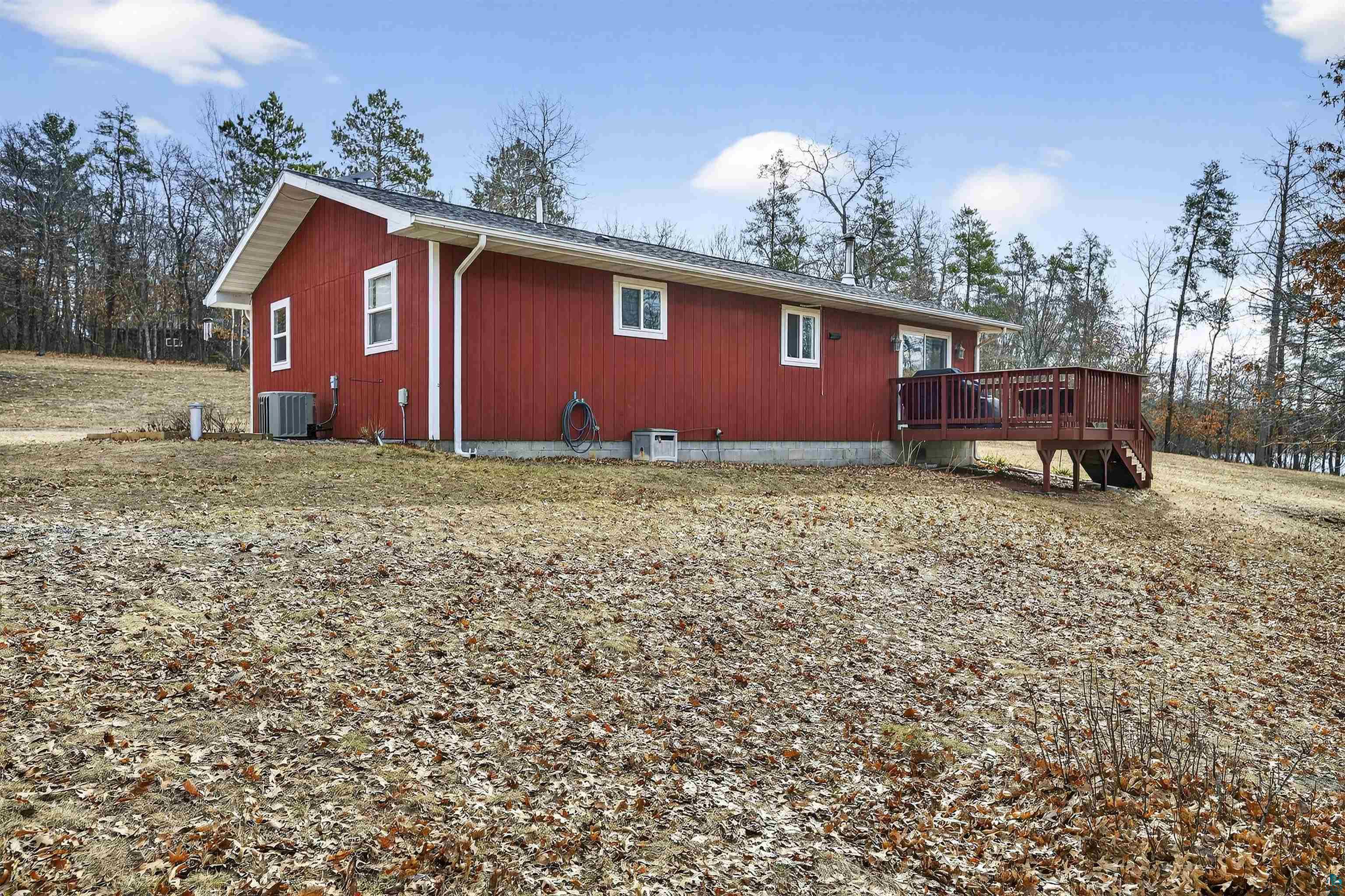 11702 East Mail Road Gordon, WI 54838 - Photo 23 of 49 View of home's exterior with a deck and a central air condition unit