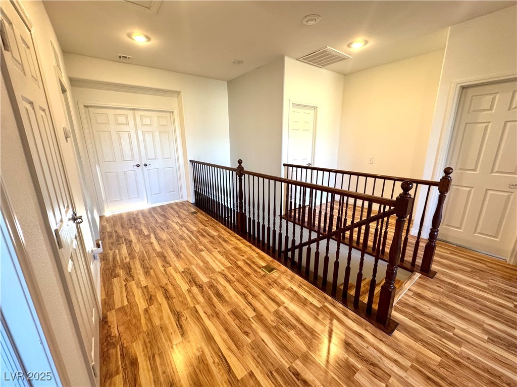 5553 Fairmeade Way Las Vegas, NV 89135 - Photo 14 of 42 Corridor featuring an upstairs landing, light wood-style floors, and recessed lighting