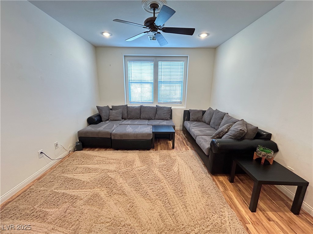 5553 Fairmeade Way Las Vegas, NV 89135 - Photo 15 of 42 Living area with light wood-style floors and ceiling fan