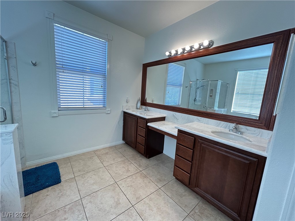 5553 Fairmeade Way Las Vegas, NV 89135 - Photo 20 of 42 Bathroom with a shower stall, double vanity, and light tile patterned floors