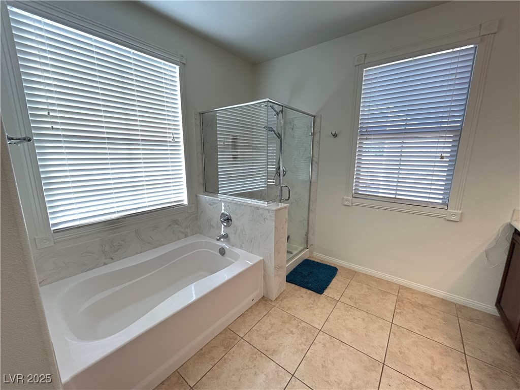 5553 Fairmeade Way Las Vegas, NV 89135 - Photo 21 of 42 Full bathroom featuring a garden tub, light tile patterned flooring, vanity, and a shower stall
