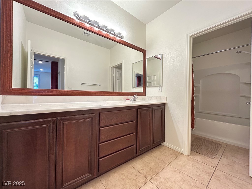 5553 Fairmeade Way Las Vegas, NV 89135 - Photo 28 of 42 Full bath with light tile patterned flooring, double vanity, and shower / bathtub combination
