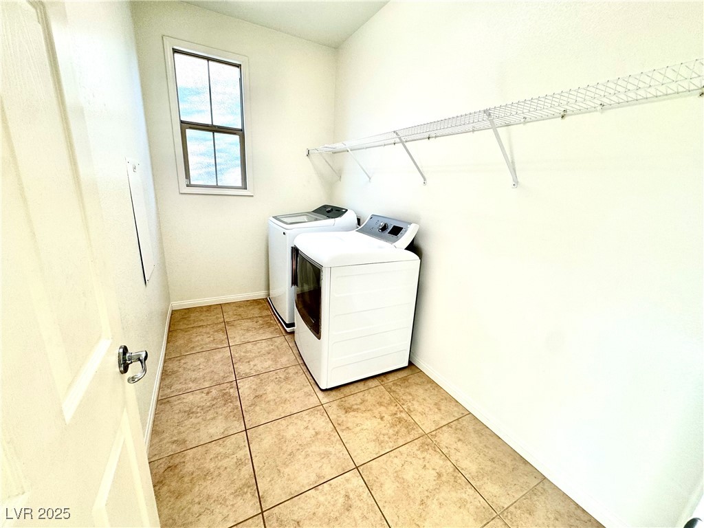 5553 Fairmeade Way Las Vegas, NV 89135 - Photo 33 of 42 Laundry room with light tile patterned floors and separate washer and dryer