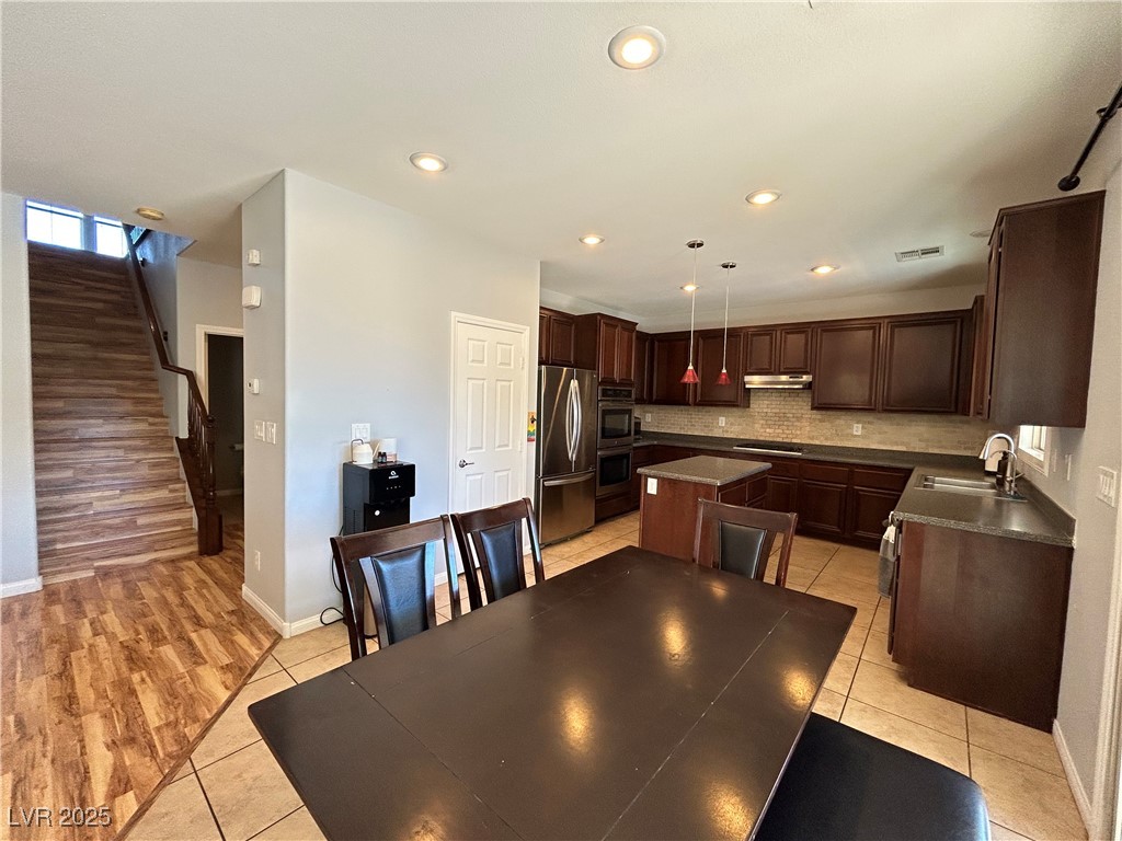 5553 Fairmeade Way Las Vegas, NV 89135 - Photo 7 of 42 Dining area featuring stairway, light tile patterned flooring, and recessed lighting