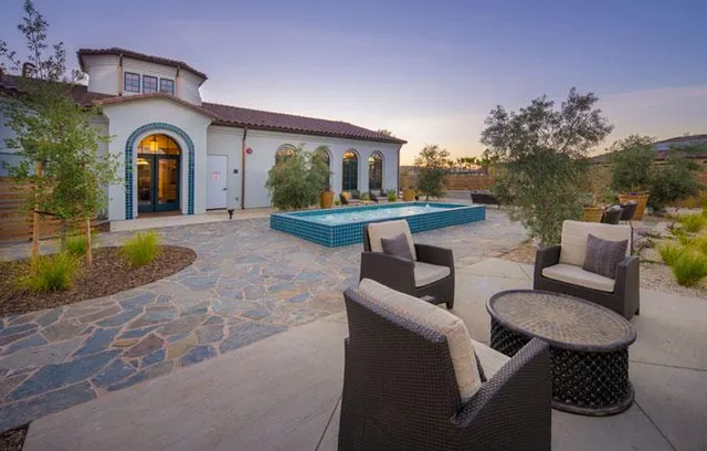 a view of swimming pool with outdoor seating and green space