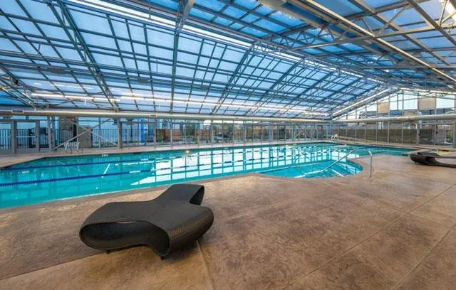 a view of a swimming pool with an outdoor space and seating area