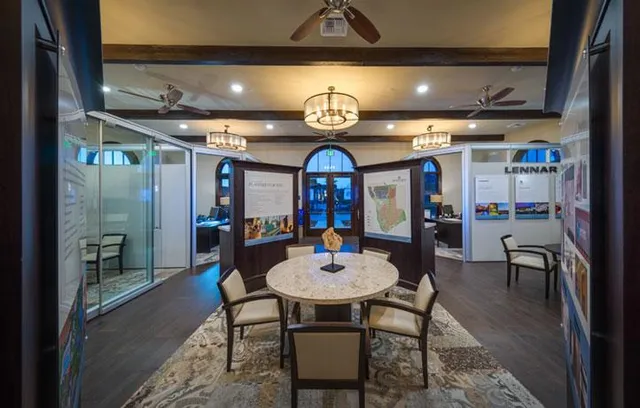 a view of a room with furniture a chandelier and wooden floor