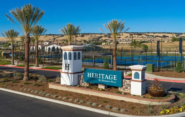 a view of a houses with backyard and tree