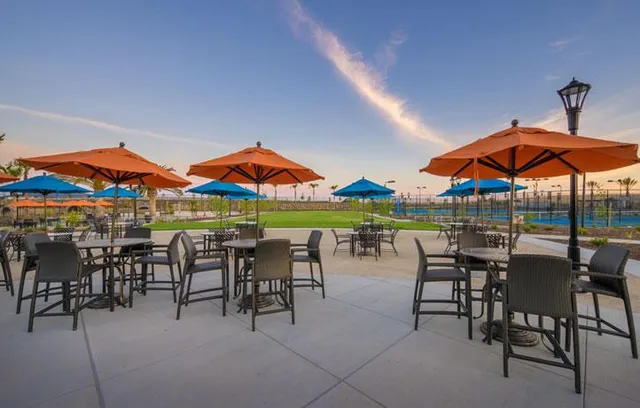 a view of a patio with a table and chairs under an umbrella