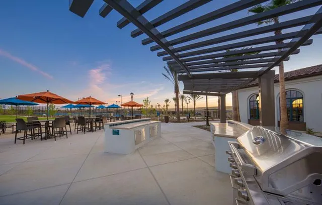 a view of a patio with a table and chairs under an umbrella