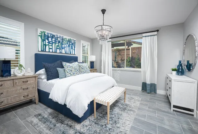 a bedroom with a large bed and a window