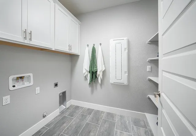a view of small space with wooden floor and cabinets