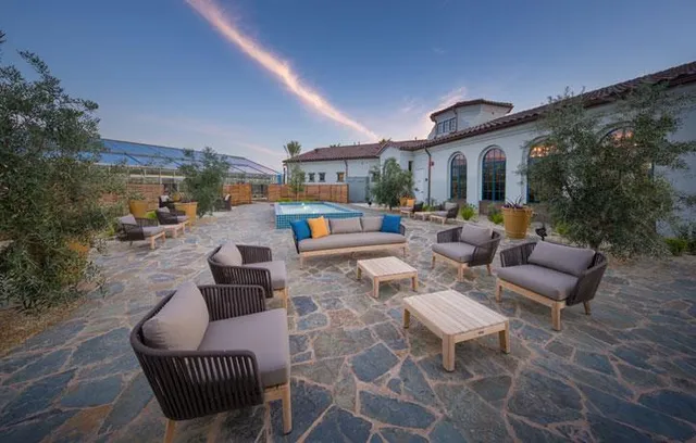 a outdoor space with patio the couches and a fireplace