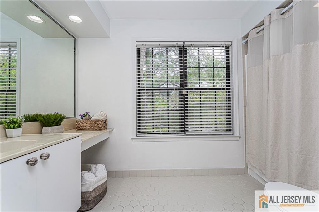 612 Chester Court Helmetta, NJ 08828 - Photo 21 of 31 a bathroom with a sink a toilet and a window