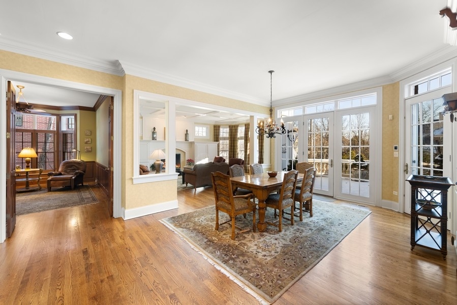 711 South County Line Road Hinsdale, IL 60521 - Photo 11 of 42 a view of a dining room and livingroom with furniture wooden floor a chandelier