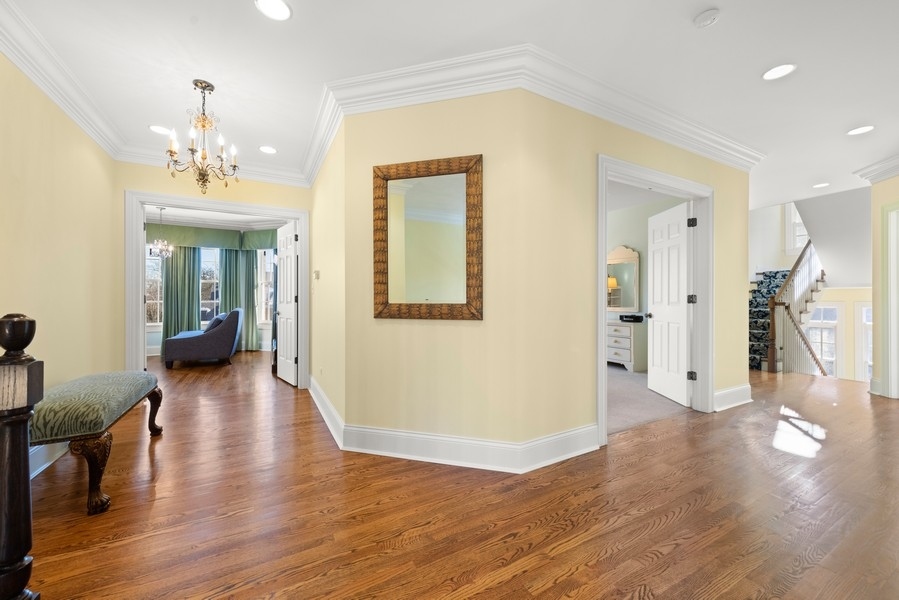 711 South County Line Road Hinsdale, IL 60521 - Photo 18 of 42 a view of a hallway with wooden floor and a bathroom