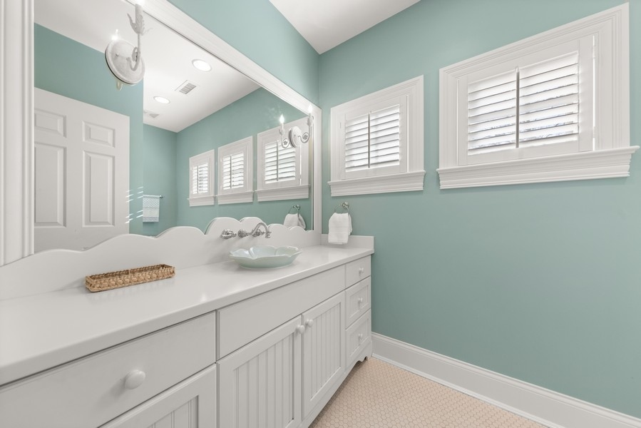 711 South County Line Road Hinsdale, IL 60521 - Photo 24 of 42 a bathroom with a sink and a mirror