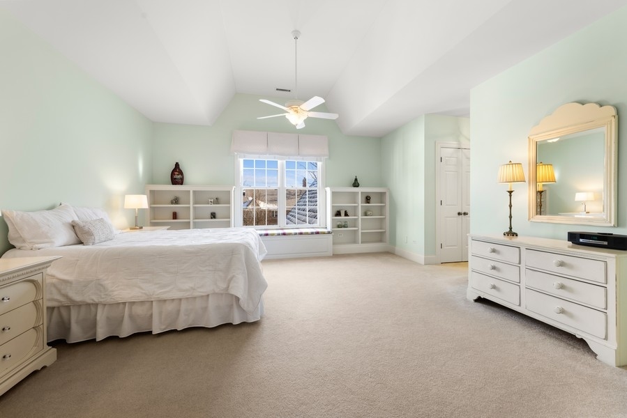 711 South County Line Road Hinsdale, IL 60521 - Photo 26 of 42 a spacious bedroom with a bed and a cabinets