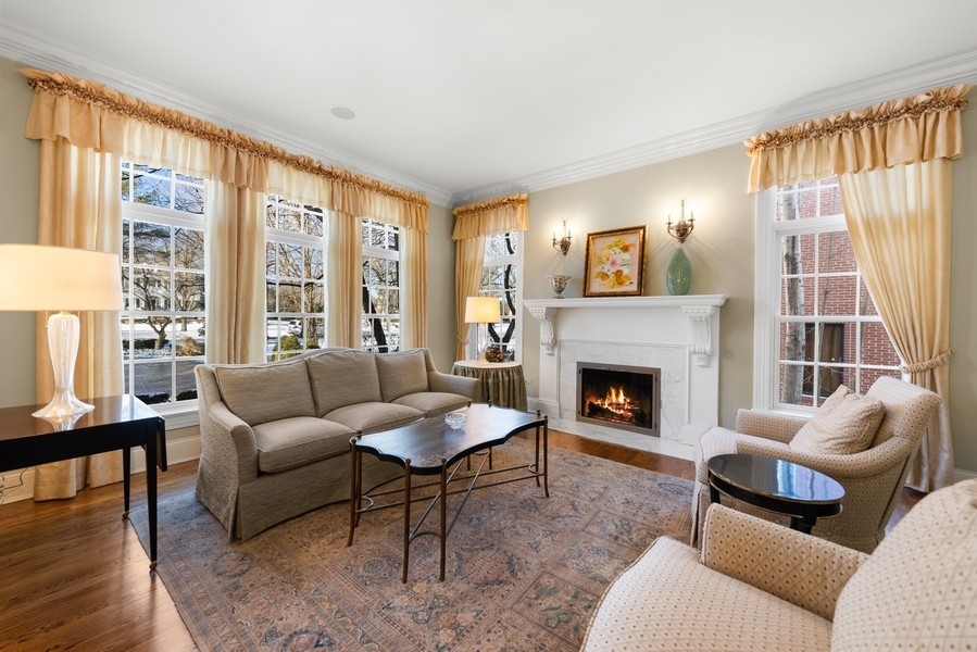 711 South County Line Road Hinsdale, IL 60521 - Photo 4 of 42 a living room with furniture a fireplace and a large window