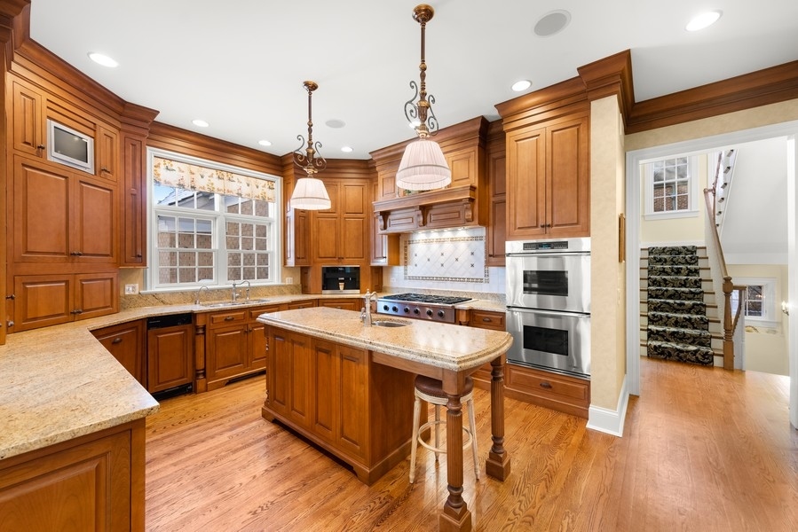 711 South County Line Road Hinsdale, IL 60521 - Photo 9 of 42 a kitchen with stainless steel appliances granite countertop a sink stove and refrigerator