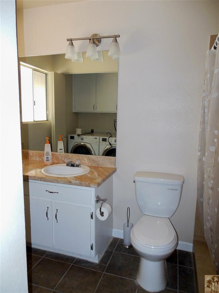 41625 Lima Hall Road Bermuda Dunes, CA 92203 - Photo 13 of 14 a bathroom with a granite countertop toilet sink and mirror