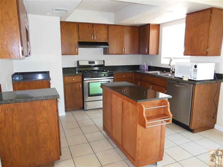 41625 Lima Hall Road Bermuda Dunes, CA 92203 - Photo 7 of 14 a kitchen with stainless steel appliances granite countertop a stove a sink and a microwave