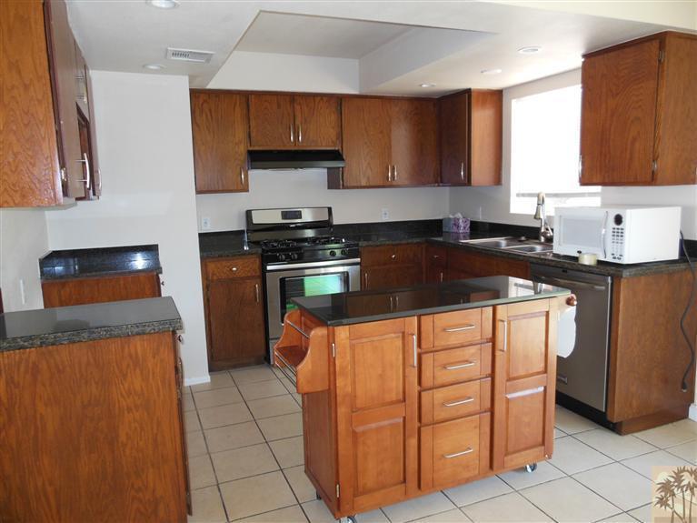41625 Lima Hall Road Bermuda Dunes, CA 92203 - Photo 8 of 14 a kitchen with stainless steel appliances granite countertop a stove a sink and a refrigerator